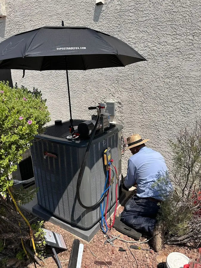 HVAC technician performing outdoor AC maintenance in Elizabethtown