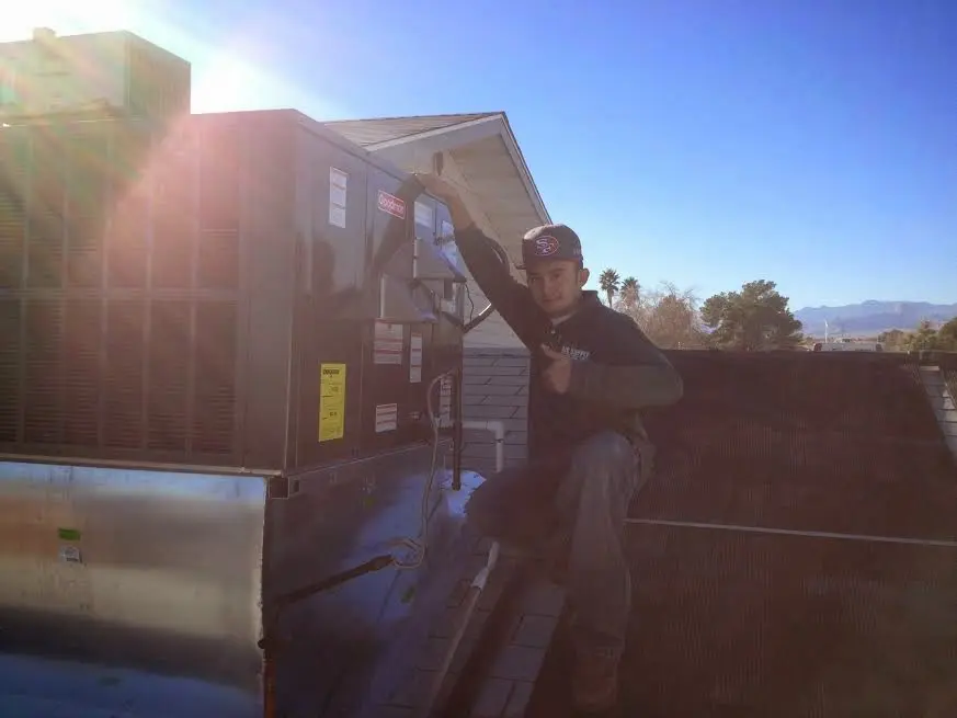 HVAC technician performing HVAC Inspection on a rooftop unit in Elizabethtown